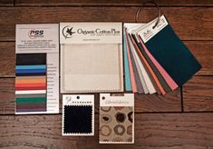 an assortment of fabric samples on a wooden surface