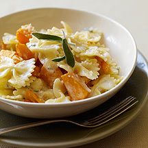 a white bowl filled with pasta and vegetables