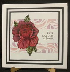 a card with an image of a red flower on the front and words that read, earth laughs in flowers