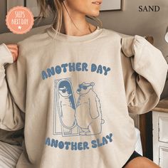 All of our Another Day Another Slay hoodies are handmade to order on an ultra soft crewneck that will quickly become your go to apparel item! You will never want to take it off! Our Meme sweatshirts are handmade to order with eco-friendly water based ink that feels good and lasts longer! ♥The details♥ This unisex sweatshirt is crafted from soft, breathable fabric for ultimate comfort. Printed with an eco-friendly water-based ink, this sweater not only looks great but also supports sustainable pr Another Day Another Slay, Crew Neck Sweater Outfit, College Sweater, Funny Bears, Funny Sweaters, Bear Hoodie, Funny Sweatshirts, Another Day, Graphic Crewneck