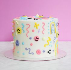 a white cake with colorful decorations on it