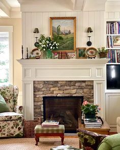 a living room filled with furniture and a fire place in front of a painting on the wall