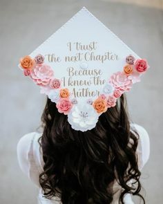 a woman wearing a white graduation cap with flowers on it's head and the words trust the next charter because i knew the author