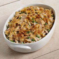 a casserole dish filled with chicken and peas