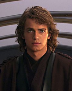 a young man with long hair wearing a star wars outfit and looking at the camera