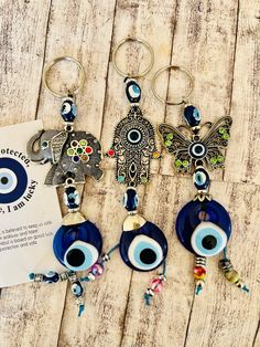 three evil eye keychains are sitting on a table