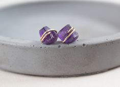 With these small studs, you will look and feel beautiful in your casual day looks and in your dressy evening out outfits, adding a pop of color. These Amethyst Earrings are featuring raw gemstones that are securely wire wrapped in 14k gold filled or sterling silver wire. Earrings measure around 10x9 mm. Amethyst is February Birthstone/ Anniversary gemstone. Each pair of earrings come with butterfly ear nuts, keeping these beauties securely in place. Your jewelry will come in a gift-ready package Purple Minimalist Earrings For Pierced Ears, Purple Minimalist Pierced Earrings, Minimalist Purple Earrings, Purple Minimalist Earrings, Earrings Studs Gold, Amethyst Earrings Studs, Silver Wire Earrings, Stone Stud Earrings, Amethyst Studs