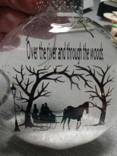 a glass ornament with a horse drawn carriage on it