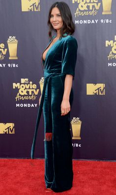 an image of a woman on the red carpet wearing a green jumpsuit and heels