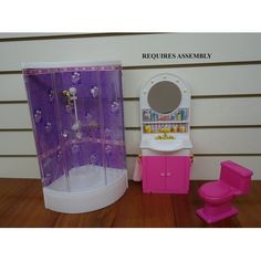 a doll house bathroom with sink, toilet and shower