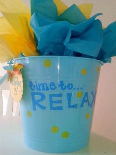 a blue bucket with some tissue paper in it and the words time to relax on it