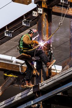 welder working on the side of a metal structure