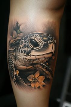 a tattoo with a turtle and flowers on it