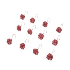 twelve red roses are hanging from hooks on a white background