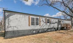 a mobile home sits in the middle of a field