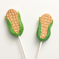 two green and white marshmallows shaped like corn on the cob with peanut butter