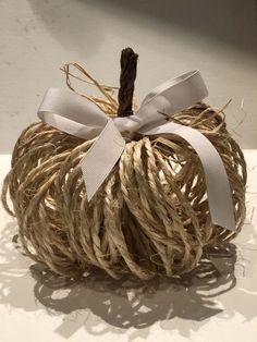 a rope wrapped pumpkin sitting on top of a table