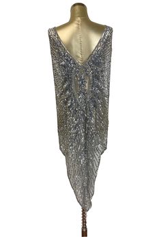 Our version of the iconic Art Deco Gown featured in the film "Blow-Up"....in a new color! Constructed on evening quality mesh, the gown is handbeaded with sparkling silver beads and sequins. A spectacular deco floral design adorns the main panel. Open above the hipline.....beaded draping on the shoulder and hip. Matching slip included. One size.....bust 34-38", waist 34", hip measurement 40", length 52" shoulder to lowest point 1920s Ball Gown, Modern Flapper Dress, Art Deco Gown, Art Deco Panel, 1920s Looks, Gatsby Headband, Deco Panel, Hollywood Dress, Mesh Gown