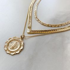 A high quality 14K Gold Filled, double sided, Mary Charm necklace Pendant is 22mm all 14K Gold Filled Choose your length: 16", 18" or 24" 1mm Ball Chain Gold Filled has 100 times more gold than gold plated jewelry. You can swim, shower, etc, this necklace is made to wear exactly like solid 14K Gold and will not chip or fade!Gold filled is created by taking a sheet of 14 karat gold and bonding it through extreme heat and pressure to a core of semi-precious metal (brass). This is a very sophistica Gold Medallion With Curb Chain Jewelry, Yellow Gold Medallion Necklace With Curb Chain, Gold Medallion Necklace With Figaro Chain, Virgin Mary Necklace Gold, Mary Necklace Gold, Sterling Silver Midi Rings, St Christopher Necklace, Mary Necklace, Virgin Mary Necklace