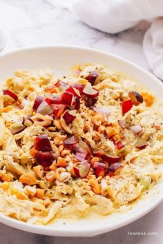 a white bowl filled with food on top of a table