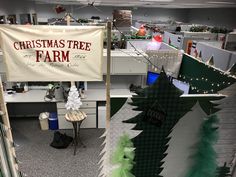 an office cubicle decorated with christmas trees and banners