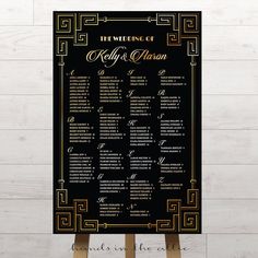 a black and gold wedding seating plan on a wooden easel with white wood flooring