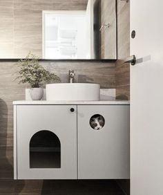 a white sink sitting under a mirror in a bathroom