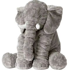 an elephant stuffed animal sitting in front of a white background