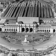 an aerial view of a large building with many people around it