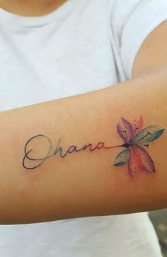 a person with a tattoo on their arm that says, chana written in cursive writing