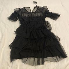 Black Net Ruffle Mini Dress From Forever 21. Never Been Worn Before & Tag Attached. Size: Small. Black Ruffled Mini Dress For Night Out, Flirty Black Mini Dress With Ruffled Skirt, Black Fitted Ruffle Dress With Tiered Shape, Black Ruffled Mini Dress For Date Night, Short Sleeve Ruffle Dress With Ruffle Hem For Party, Chic Black Dresses With Layered Hem, Black Fitted Tiered Ruffle Dress, Black Ruffle Dress For Summer, Black Ruffle Dress For Summer Party