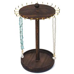 a wooden jewelry stand with beads and necklaces hanging from it's sides on a white background