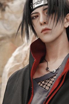 a man with black hair and piercings on his head