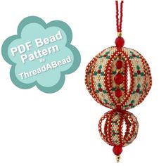 a beaded ornament hanging from a red string with beads and beads on it