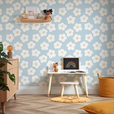 a child's room with blue and yellow wallpaper, a white desk and chair