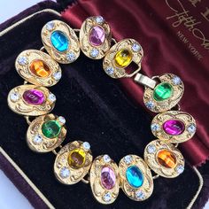 ON SALE Very nice colorful glass rhinestone collectible high and vintage bracelet in excellent vintage condition. Measures 7 1/4 inches long by three-quarter inches wide. A perfect addition to any collection. Retro Rhinestone Jewelry For Gifts, Collectible Costume Jewelry With Jewels, Vintage Multicolor Rhinestone Jewelry, Costume Jewelry Jeweled Bracelets For Gift, Jeweled Costume Jewelry Bracelets For Gift, Costume Jewelry Crystal Bracelet For Gift, Oval Multicolor Jeweled Jewelry, Collectible Metal Jewelry With Jewels, Vintage Multicolor Stone Bracelets