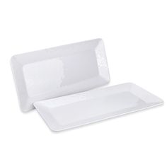 two white dishes sitting next to each other