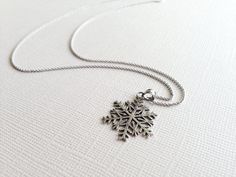 This beautiful snowflake pendant is hand crafted in sterling silver and comes with a 16 inch Rhodium Plated Italian Link Chain. This charming necklace will make the perfect holiday gift and add a meaningful touch to the intended wearer's taste and personality. Material: Sterling Silver Pendant Size: 1 inches long Chain Length: 16 inch Rhodium Plated Italian Cable Chain *Nickel-Free = Hypoallergenic *All purchases will arrive in a gift box! *Available in silver, Rose gold plated and yellow gold p Sterling Silver Snowflake Jewelry For Winter, Sterling Silver Jewelry For Winter Gifts, Sterling Silver Necklaces For Winter Gifts, Silver Jewelry For Winter Gift, Silver Jewelry As Winter Gift, Holiday Sterling Silver Necklaces, Sterling Silver Snowflake Jewelry, Silver Snowflake Necklace For Gift, Holiday Sterling Silver Necklaces In Silver