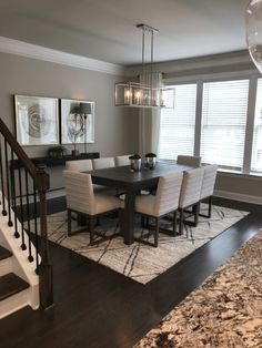 a dinning room table with chairs and a chandelier