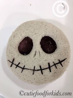 a close up of a cake decorated to look like a skull with eyes and mouth