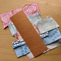 several pieces of fabric sitting on top of a wooden table