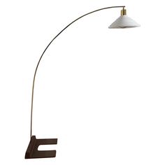 a floor lamp with a white shade on it's side and a black base