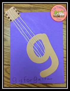 a purple paper with the letter g on it and an image of a guitar that says gis for guitar