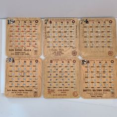 four wooden coasters with numbers and symbols on them are arranged in a grid pattern