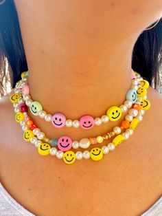 🌈 Cutest pearly rainbow smiley face necklace! 🌈  Getting into summer trends hasn't been more easy. With pastel colors this necklace is the perfect companion to any outfit. The "Smile" collection is meant to be for anyone who likes to have fun and be spontaneous! Materials: Beaded pearls and Smiley faces Electroplated Plastic Mix 14K gold plated lock and extensor Size: 14 inches or 35.6 cm + 2 inch/ 5cm extensor Jewelry Care: *Allow perfumes and lotion to dry before wearing. *Remove before show Smiley Face Bracelets, Trendy Yellow Beaded Necklaces, Fun Adjustable Necklace For Everyday, Fun Adjustable Necklace For Everyday Wear, Fun Adjustable Everyday Necklace, Adjustable Fun Everyday Necklace, Trendy Rainbow Necklaces For Summer, Fun White Beaded Necklaces For Summer, Trendy Summer Beaded Necklaces