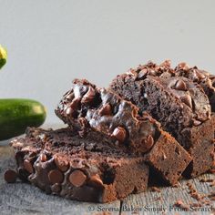 some chocolate brownies are stacked on top of each other and one is cut in half