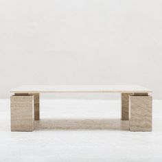 a white table sitting on top of a white floor