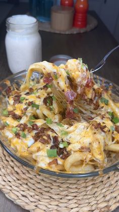 a glass bowl filled with pasta and cheese