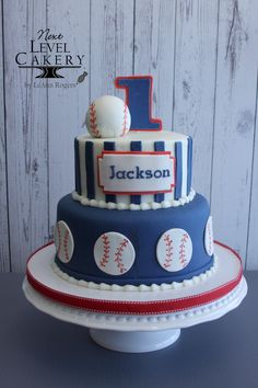 a baseball themed birthday cake with the number one on top