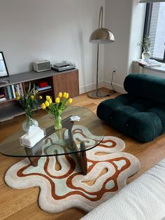 a living room filled with furniture and a glass table